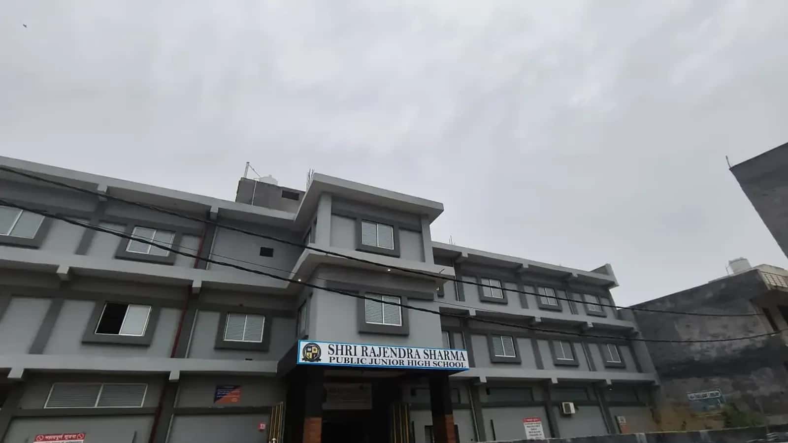School building with the school name board above the entrance